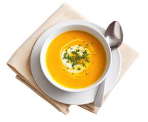 Creamy, vibrant orange soup in a white bowl, garnished with herbs and a dollop of cream