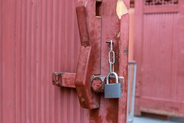 The latch on the red wooden door