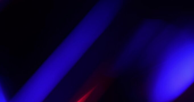 Light leak background. Vibrant Prism Light Streaks in Motion. Video capturing dynamic streaks of blue, purple, pink, and red lights - real effect.	
