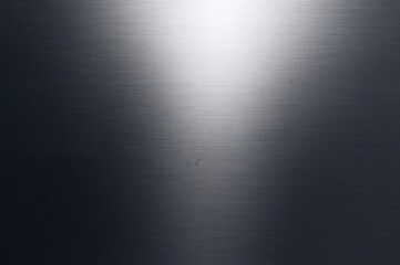 Fototapeta premium Top-down view of a textured metallic grey surface with gradient lighting and ample copy space for a screensaver