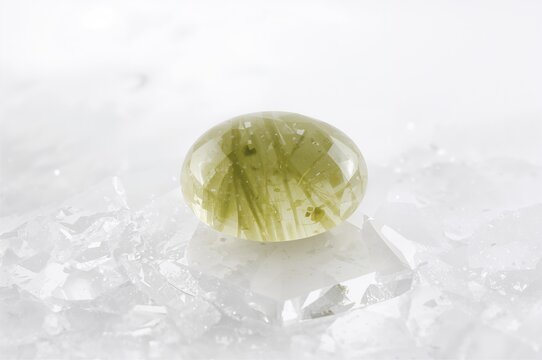 Close-up of macro prehnite mineral specimen against a white backdrop