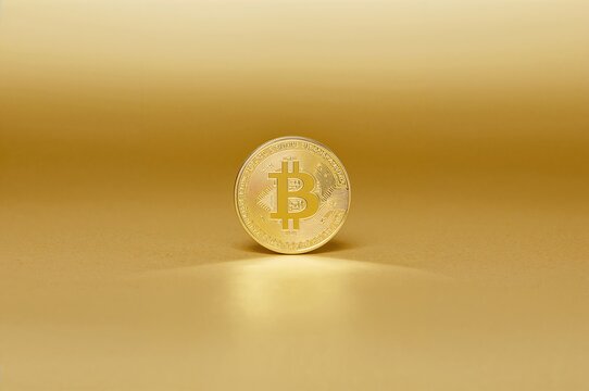 Cryptocurrency token on a golden surface