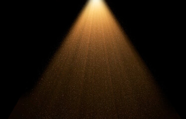 Golden spotlight is illuminating dust particles floating in dark room