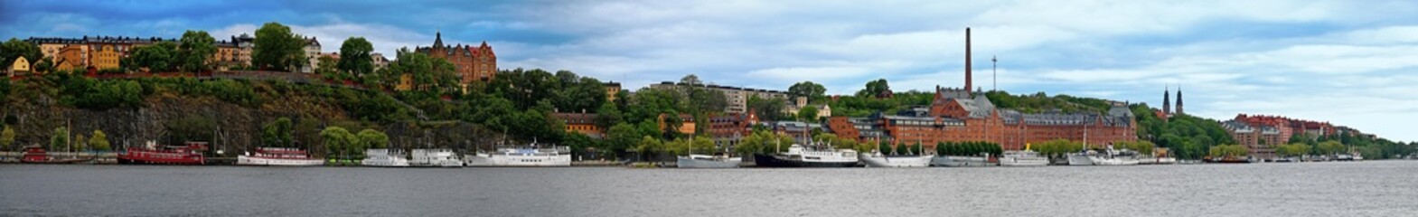 Panorama of Södermalm on the south shore of Riddarfjärden with the buildings of Mariaberget, a former brewery and ships at the quay in Stockholm, Sweden