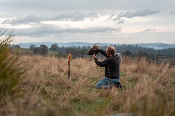 farmer collecting soil samples in a test tube in a field. Agronomist checking soil carbon and plant health on a farm