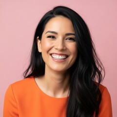 Smiling woman with long dark hair in an orange top