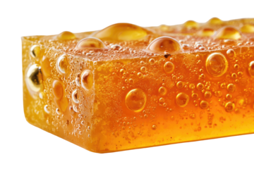 Close-up of a honey-colored, translucent block with bubbles