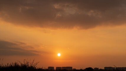 The setting sun, its afterglow, and the natural scenery