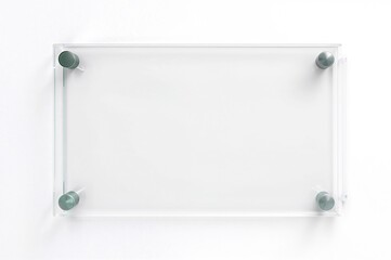 Transparent green glass nameplate mounted on metal spacers. Clear acrylic branding board with printed design. Side view of advertising sign on white background mock-up.