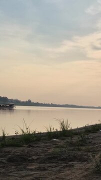 Peaceful view of the Mekong River with boats at night in Laos