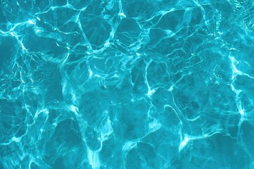 Obraz premium Blue mint water with ripples and circular waves, white textured surface. Spa theme background with space for text, square layout from above.