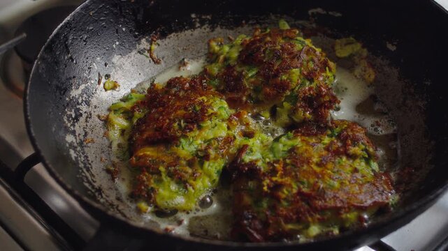 Close-up of vegetable vegetarian pancakes fried in boiling oil in a pan