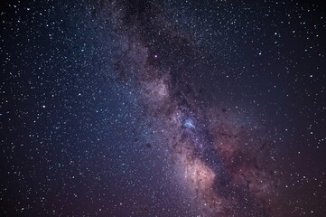 Obraz premium Starry night with twinkling stars and a colorful nebula set against a deep blue and purple universe