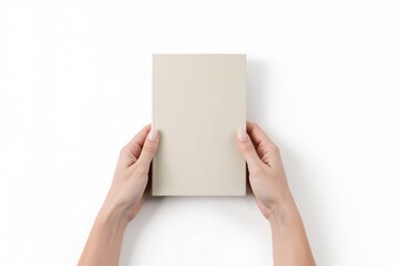 Closed book cover held by hands, blank hardcover on white background mockup