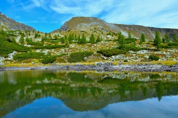 Rosennock mountain peak above Naßbodensee lake with a reflection in the water in Nock mountains and Gurktal alps in Carinthia, Austria