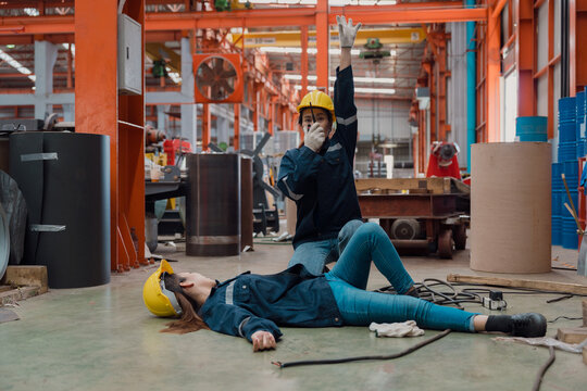A female worker is helping her friend after being electrocuted in a metal cheese factory.