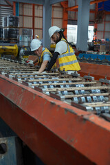 Engineers and staff are inspecting the assembly line system in a metal sheet and metal roofing...