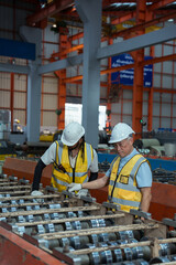 Engineers and staff are inspecting the assembly line system in a metal sheet and metal roofing...