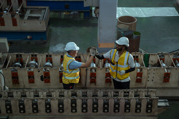 Engineers and staff are inspecting the assembly line system in a metal sheet and metal roofing...