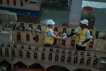 Engineers and staff are inspecting the assembly line system in a metal sheet and metal roofing...