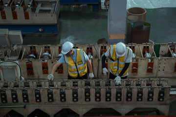 Engineers and staff are inspecting the assembly line system in a metal sheet and metal roofing...