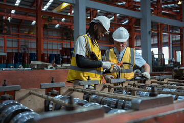 Engineers and staff are inspecting the assembly line system in a metal sheet and metal roofing...