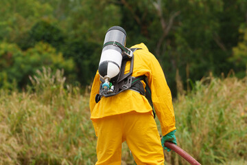 Fototapeta premium Chemical inspectors are checking for chemical leaks during a fire.