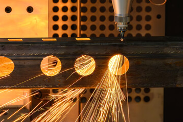 Close up scene the fiber laser cutting machine cut the square shape stainless steel tube with...