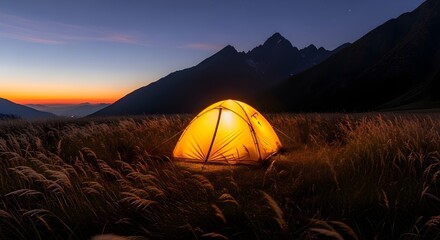 A glowing tent under a twilight sky, nestled in a sea of grass before a silhouetted mountain range.