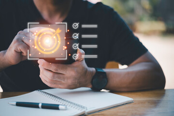 Business planning concept and strategic goal setting and with a businessman pointing at a target icon and checklist. Ideal for success, productivity, project execution and leadership content.