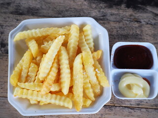 Crinkle-cut fries. French fries are fried hot, sprinkled with a little salt, and served with ketchup and mayonnaise. Potatoes cut into sticks and fried in hot oil are popular as a snack or side dish. 