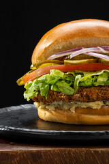 
American burger, with meat, cheese, lettuce, tomato, onion, mayonnaise and pickles