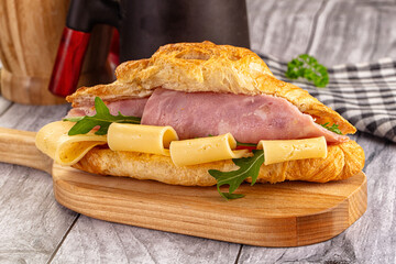 Fresh croissant with ham and cheese