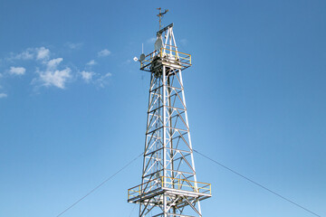 Metalic antenna receiver in front of clear sky 