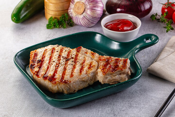 Tasty hot grilled bone steak served sauce