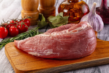 Raw pork sirloing over board