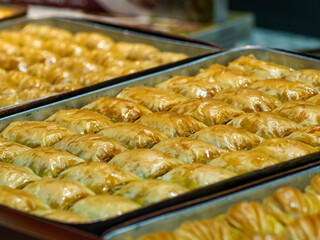 A large tray of freshly baked traditional baklava a rich and sweet pastry made with layers of phyllo dough nuts and honey syrup a popular dessert