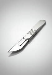 Obraz premium A close-up, high-angle shot of a shiny silver surgical scalpel with a sharp blade on a clean white background.
