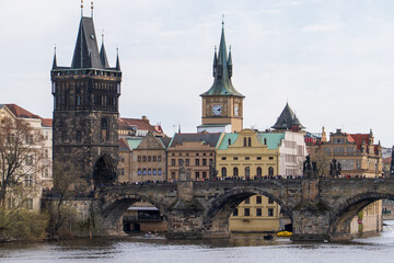 Prague, Czech Republic - April 5, 2025: View of the Charles Bridge and the Vltava River with ships passing by