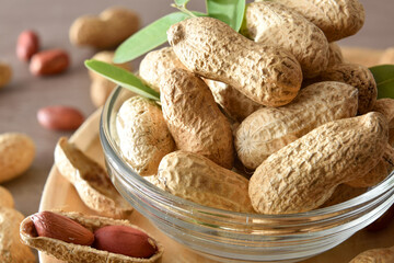 Macro view of group of peanuts in bowl on table