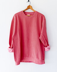 Cozy vintage-style bright red watermelon crewneck sweatshirt on wooden hanger, back view,...