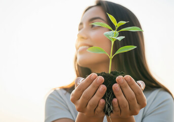 Woman holding a small plant