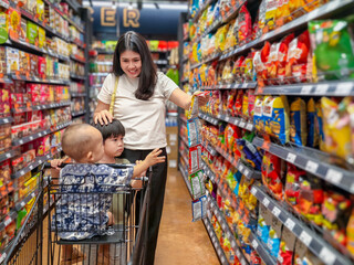 woman with two children in a grocery store