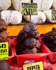 Stall selling varieties of fresh mole at the San Juan Market in Mexico City.