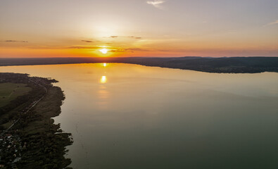 Spectacular sunset over lake Balaton with golden reflections, Hungary.