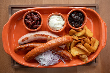 Savoring a delightful spread of sausages and sides at a cozy restaurant