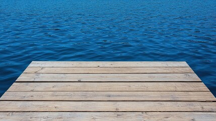 Fototapeta premium Wooden pier on blue water background