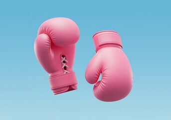 Pink boxing gloves floating against a clear blue background symbolizing breast cancer awareness month and fighting for a cure