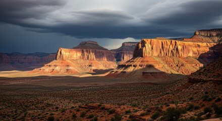 Majestic canyon landscape under a dramatic, stormy sky with sunlit rock formations.