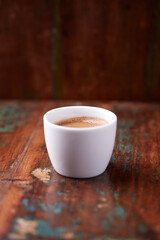 Cup of coffee on rustic wooden background. Soft focus. Copy space	